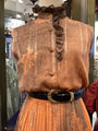 Vintage-style vest with ruffled collar on a mannequin in a store setting