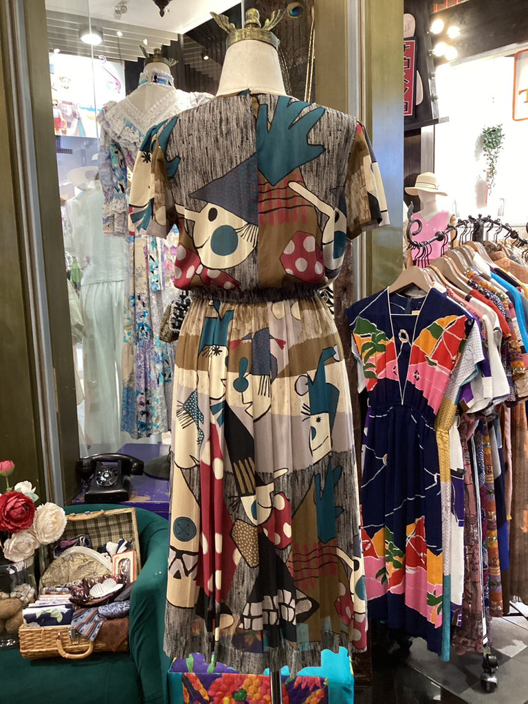 Colorful vintage dress on a mannequin with a store interior background