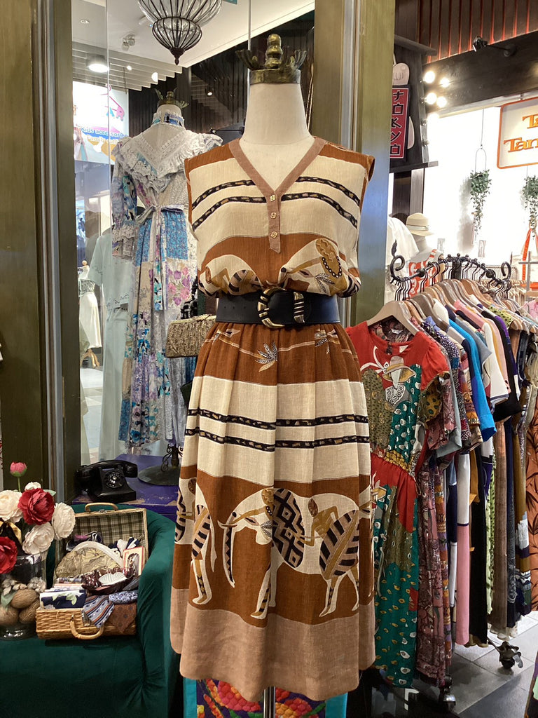 Vintage dress with horse design on a mannequin in a store setting.