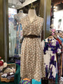 Mannequin wearing a floral dress in a clothing store setting