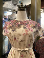 Floral dress on a mannequin in a store setting