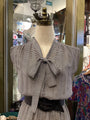 Black and white striped blouse on a mannequin in a store setting