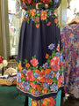 Navy blue skirt with colorful floral patterns on a mannequin in a store setting.