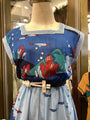 Colorful dress with abstract patterns on a mannequin in a store setting