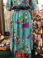 Colorful dress with abstract patterns on a mannequin in a store setting.