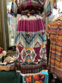 Colorful patterned dress on a mannequin in a store setting