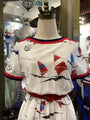 Mannequin wearing a dress with sailboat design in a store setting