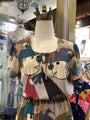 Colorful abstract-patterned dress on a mannequin in a store setting