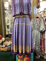 Vintage dress with plaid pattern and floral details in a store setting