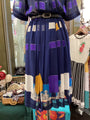 Colorful dress with geometric pattern on a hanger in a store setting