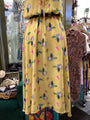 Yellow floral dress on a mannequin in a clothing store