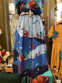 Colorful dress with underwater-themed design on a mannequin in a store setting.