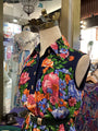 Mannequin wearing a colorful floral shirt in a store setting