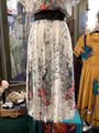 Floral dress on a mannequin with a colorful background