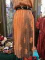 Mannequin wearing a brown pleated skirt with a belt in a store setting