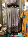 Mannequin wearing a patterned dress with a colorful background