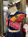 Mannequin wearing a colorful dress with geometric patterns in a store setting