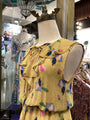 Yellow floral dress on a mannequin in a store setting