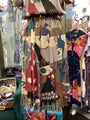 Colorful vintage dress with abstract patterns in a store setting
