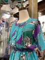 Mannequin wearing a colorful dress with a pattern in a store setting