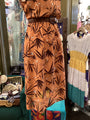 Brown dress with leaf pattern on a mannequin in a store setting