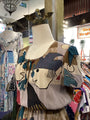 Mannequin wearing a colorful dress with a face design in a store setting