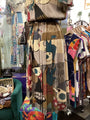 Colorful dress with abstract patterns on a mannequin in a clothing store.