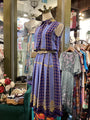 Mannequin wearing a blue plaid dress in a clothing store