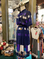 Mannequin wearing a colorful dress with geometric pattern in a store setting