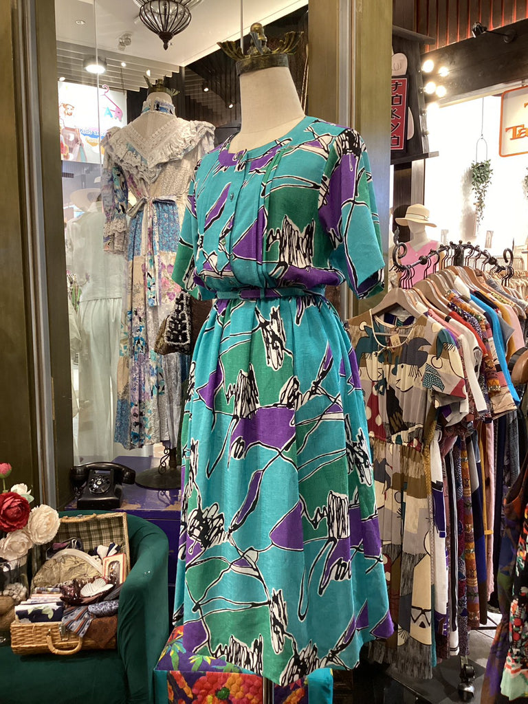 Mannequin wearing a colorful dress in a clothing store