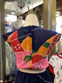 Colorful kimono-style garment on a mannequin in a store setting