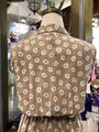 Floral patterned vest on a mannequin in a store setting