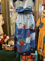 Colorful dress with sea-themed design on a mannequin in a store setting.