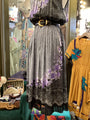 Mannequin wearing a patterned dress with a belt in a store setting