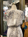 Floral dress on a mannequin with a blurred store interior background