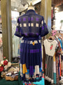 Colorful dress on a mannequin in a store setting with other clothing items.