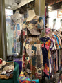 Colorful dress on a mannequin in a store setting with various clothing items.