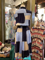 Mannequin wearing a patchwork dress in a clothing store