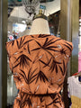 Brown dress with leaf pattern on a mannequin in a store setting