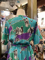 Mannequin wearing a colorful dress with abstract patterns in a store setting
