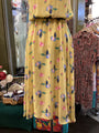 Yellow floral dress on a mannequin in a clothing store