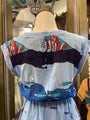 Mannequin wearing a colorful shirt with abstract designs in a store setting
