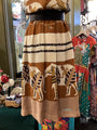 Mannequin wearing a patterned dress with animals in a store setting