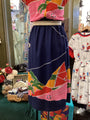 Colorful dress with abstract patterns on a mannequin in a store setting.