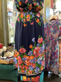Colorful floral dress on a mannequin in a store setting
