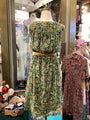 Vintage dress with floral pattern on a mannequin in a store setting