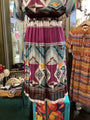 Colorful patterned dress on a mannequin in a store setting