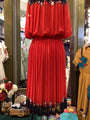 Red dress with floral details on a mannequin in a store setting