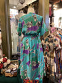 Colorful dress with abstract pattern on a mannequin in a store setting.